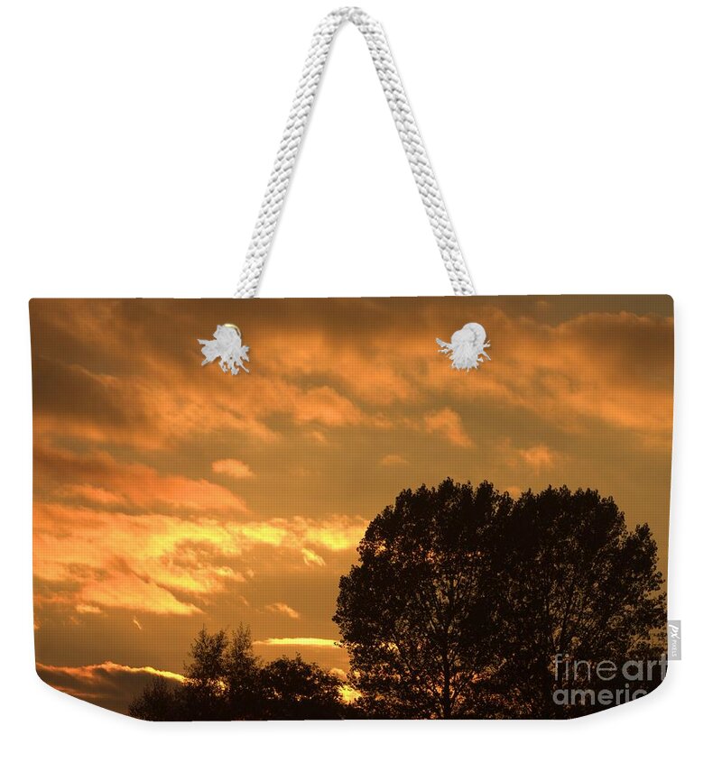 Sunset Silhouette Weekender Tote Bag featuring the photograph Golden Sunset Clouds by Jeremy Hayden