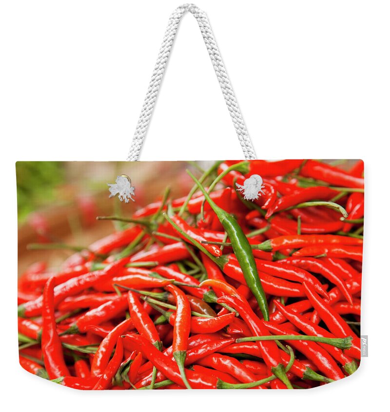 Heap Weekender Tote Bag featuring the photograph Green Chili On A Heap Of Red Chilli by Dejan Patic