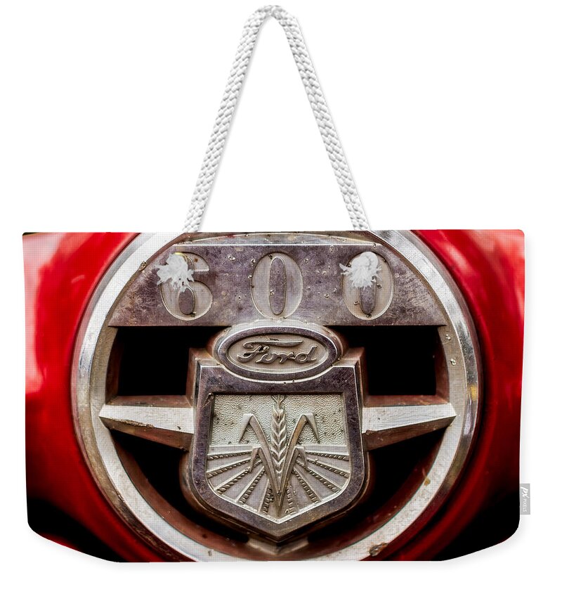 Ford Weekender Tote Bag featuring the photograph Grill logo detail - 1950s-Vintage Ford 601 Workmaster Tractor by Jon Woodhams