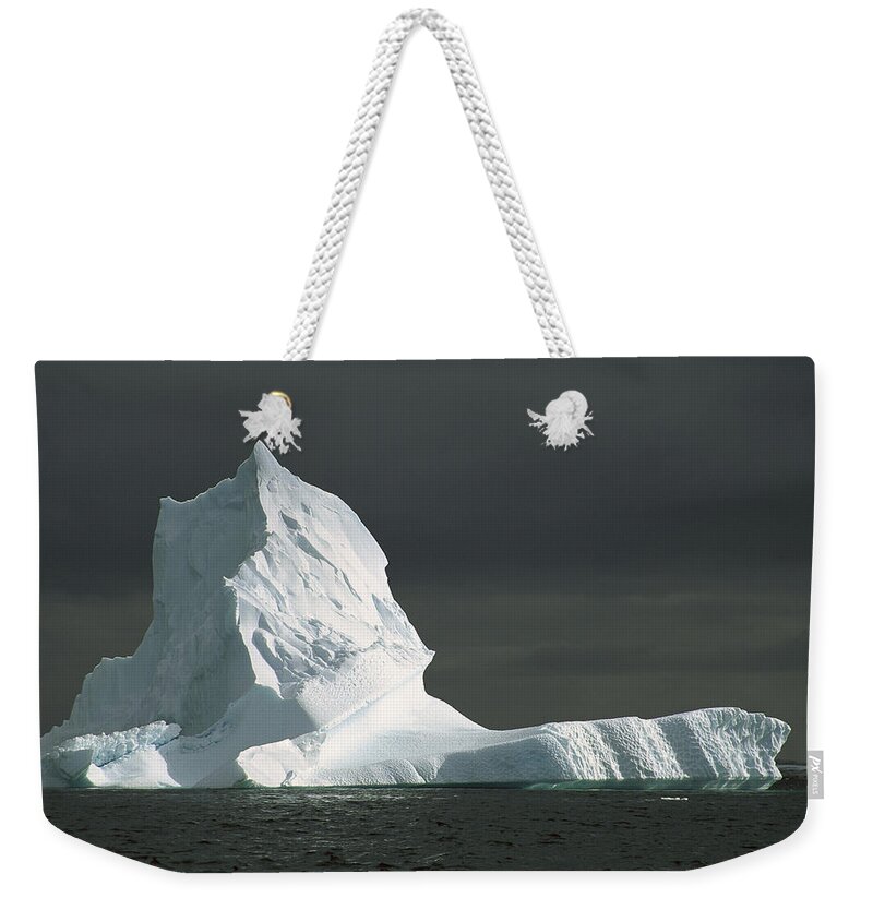 Feb0514 Weekender Tote Bag featuring the photograph Grounded Iceberg With Storm Clouds by Colin Monteath