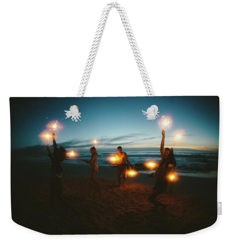 Water's Edge Weekender Tote Bag featuring the photograph Group Of Friends With Fireworks by Wundervisuals