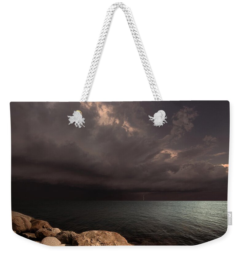Sea Clouds Bay Water Seascape Landscape Balticsea Rocks Shore Storm Light Lightning Calm Sun Sky Nature Photomontage Photomanipulation Weekender Tote Bag featuring the photograph Heart of the Tempest by Michal Karcz
