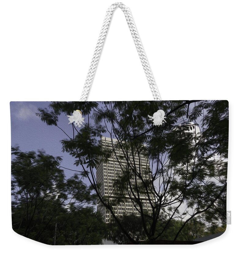 Action Weekender Tote Bag featuring the digital art High rise buildings behind trees in Singapore by Ashish Agarwal