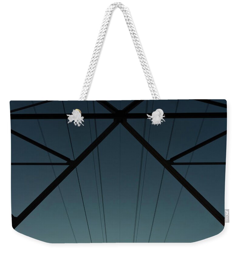 Tranquility Weekender Tote Bag featuring the photograph High Tension Tower With Cables At by Michael Sommerauer