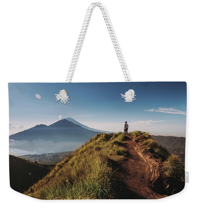 Shadow Weekender Tote Bag featuring the photograph Hiker Staying On Top Of Mount Batur by Alex Grabchilev / Evgeniya Bakanova