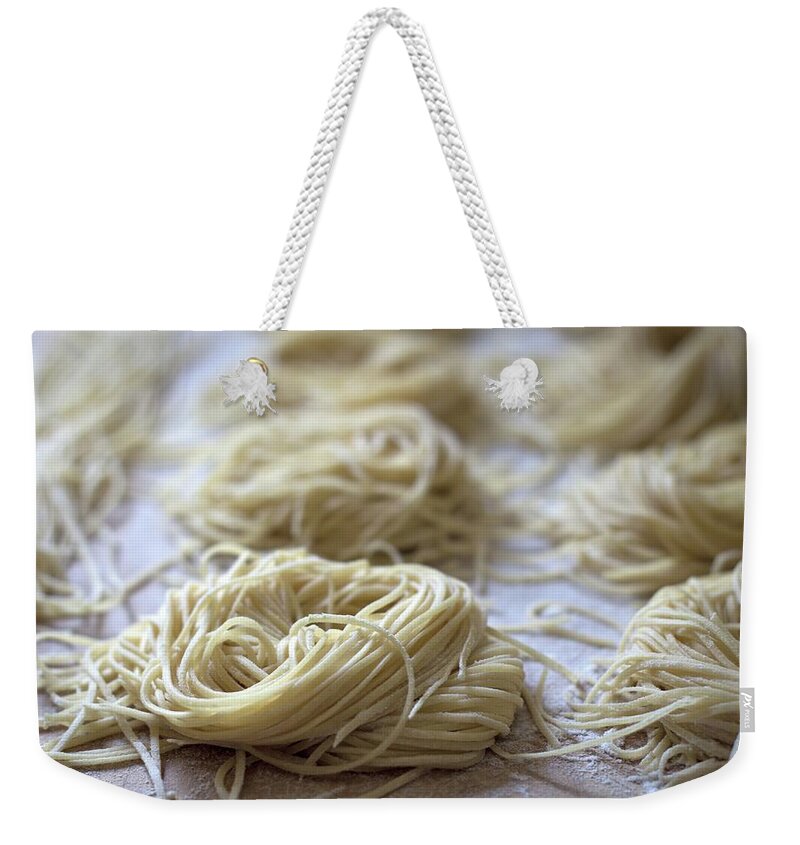In A Row Weekender Tote Bag featuring the photograph Homemade Pasta by © 2011 Staci Kennelly