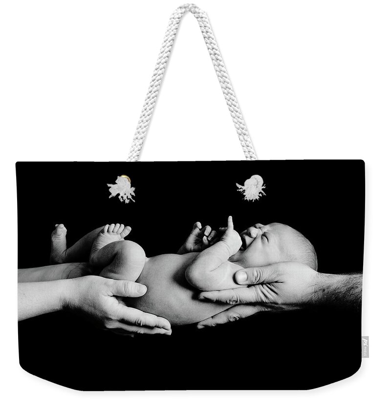 Newborn Weekender Tote Bag featuring the photograph In Your Hands by Sebastian Musial