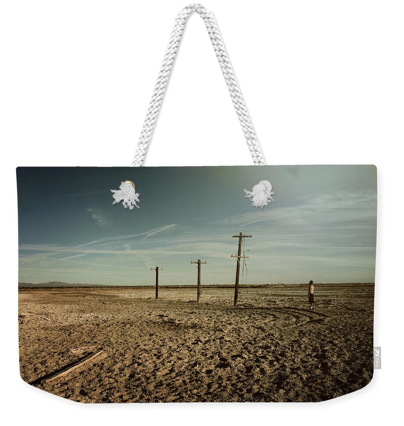 Niland Weekender Tote Bag featuring the photograph It Was a Strange Day by Laurie Search