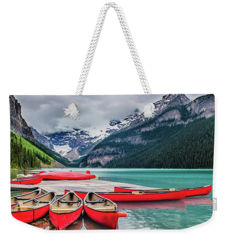 Snow Weekender Tote Bag featuring the photograph Lake Louise Canoes by Wr Mekwi
