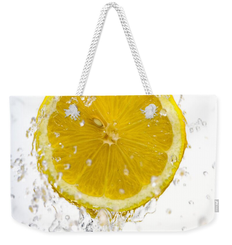 Lemon Weekender Tote Bag featuring the photograph Lemon Splash by Alexey Stiop