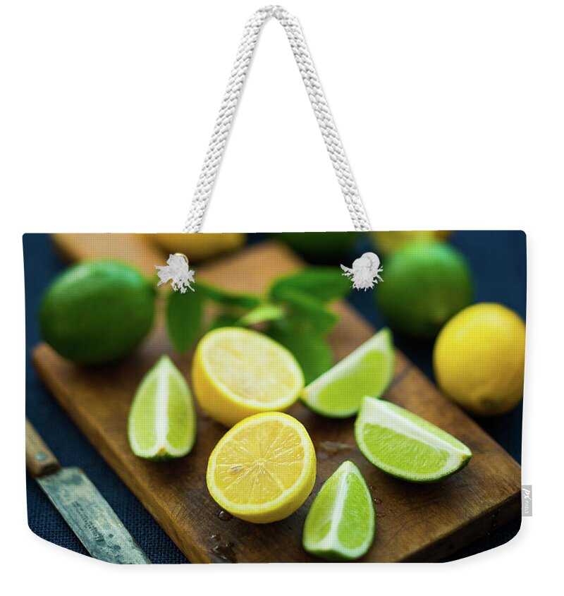 Orange Color Weekender Tote Bag featuring the photograph Lemons And Limes by Thepalmer