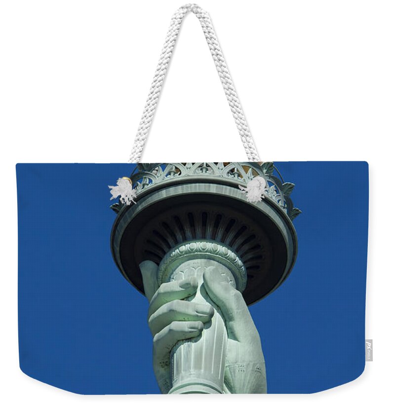 New York Weekender Tote Bag featuring the photograph Liberty Torch by Brian Jannsen