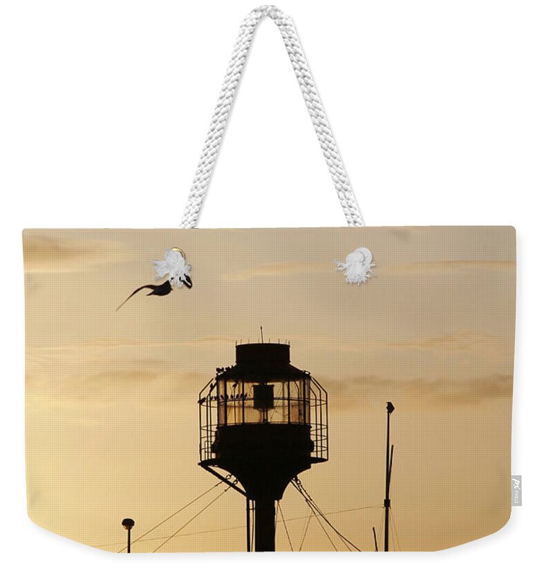 Light Weekender Tote Bag featuring the photograph Light ship silhouette at sunset by Steve Ball