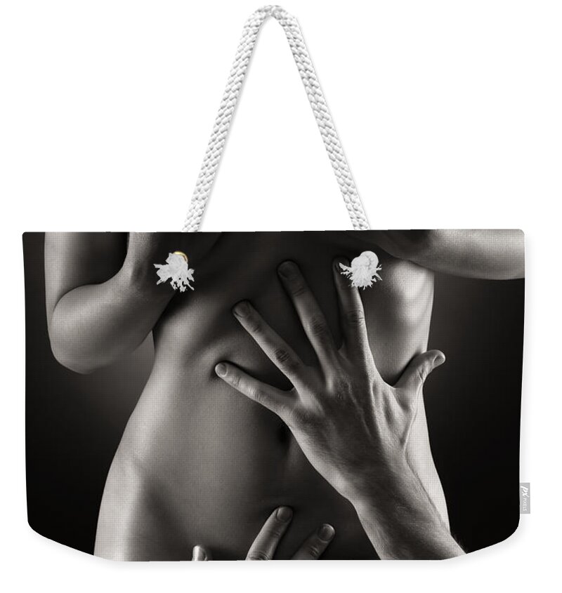Sensual Weekender Tote Bag featuring the photograph Man hands on nude woman body Black and white by Maxim Images Exquisite Prints