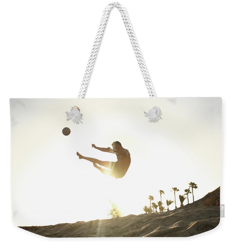People Weekender Tote Bag featuring the photograph Man Playing Beach Soccer by Stanislaw Pytel