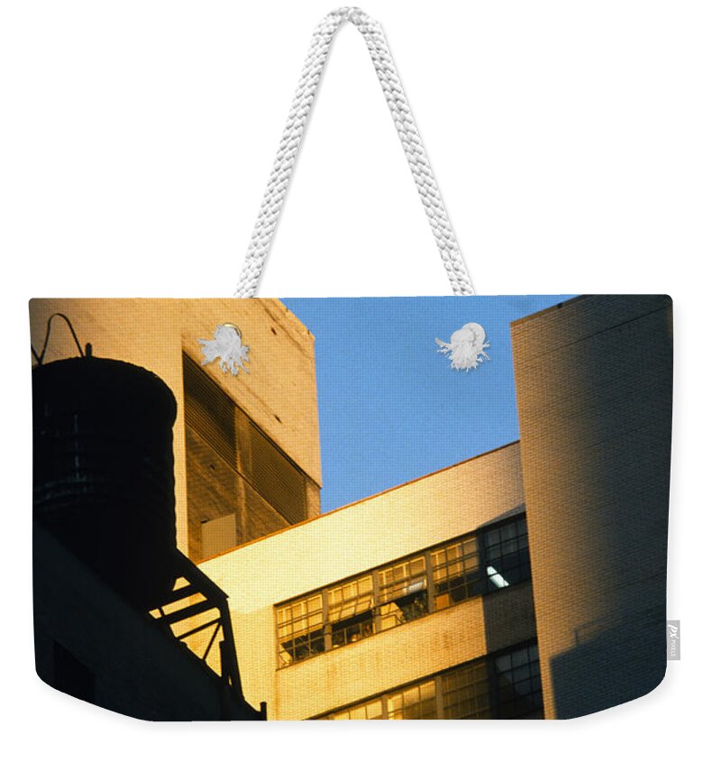 Manhattan Weekender Tote Bag featuring the photograph Manhattan Rooftop Sunlight and Shade by Gordon James