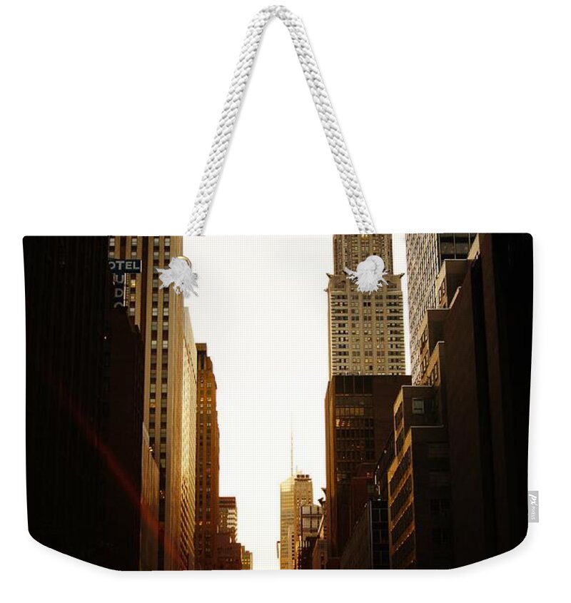 New York City Weekender Tote Bag featuring the photograph Manhattanhenge Sunset and the Chrysler Building by Vivienne Gucwa
