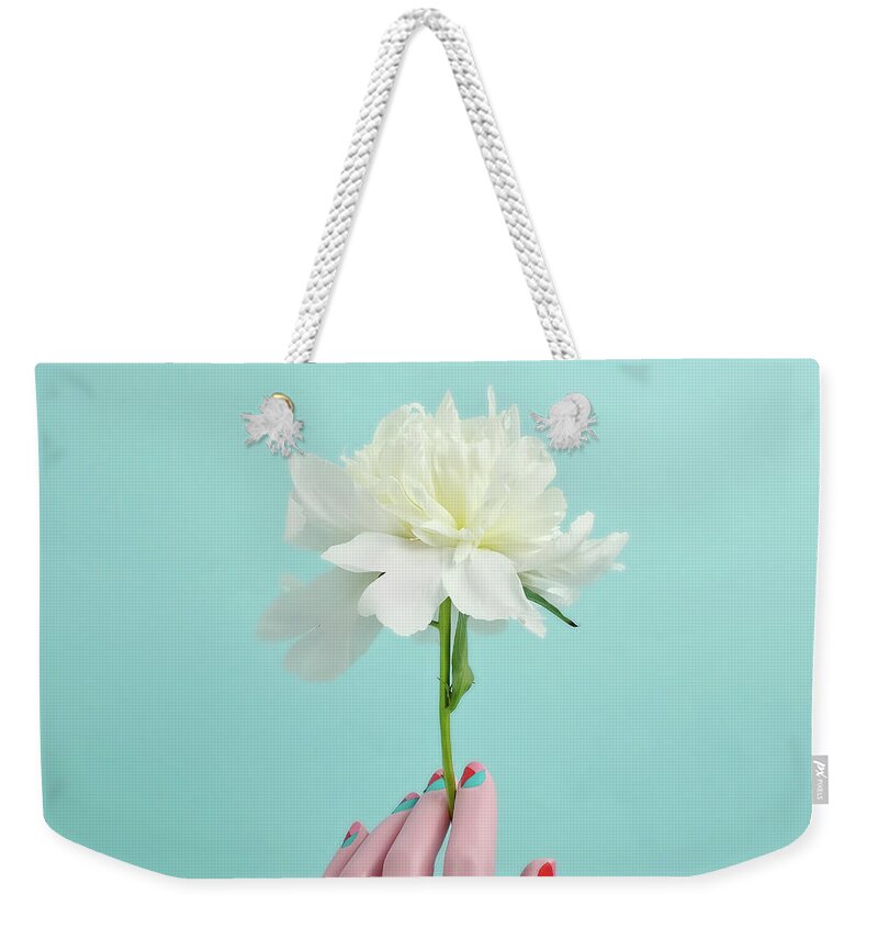 People Weekender Tote Bag featuring the photograph Mannequin Hand Holding White Peony by Juj Winn