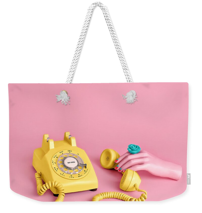 Artificial Weekender Tote Bag featuring the photograph Mannequin Hand Holding Yellow Rotary by Juj Winn