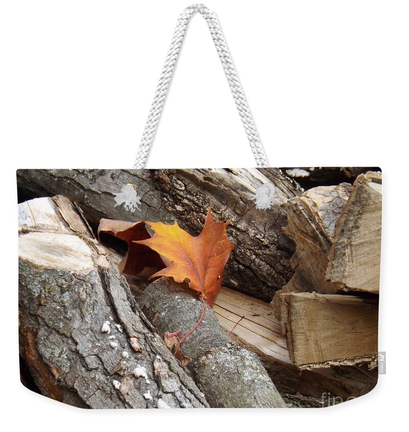 Leaf Weekender Tote Bag featuring the photograph Maple Leaf in wood pile by Brenda Brown