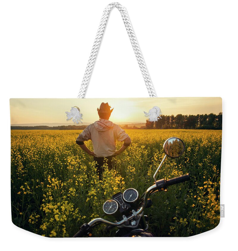Tranquility Weekender Tote Bag featuring the photograph Mari Man Standing Near Motorcycle In by Aliyev Alexei Sergeevich