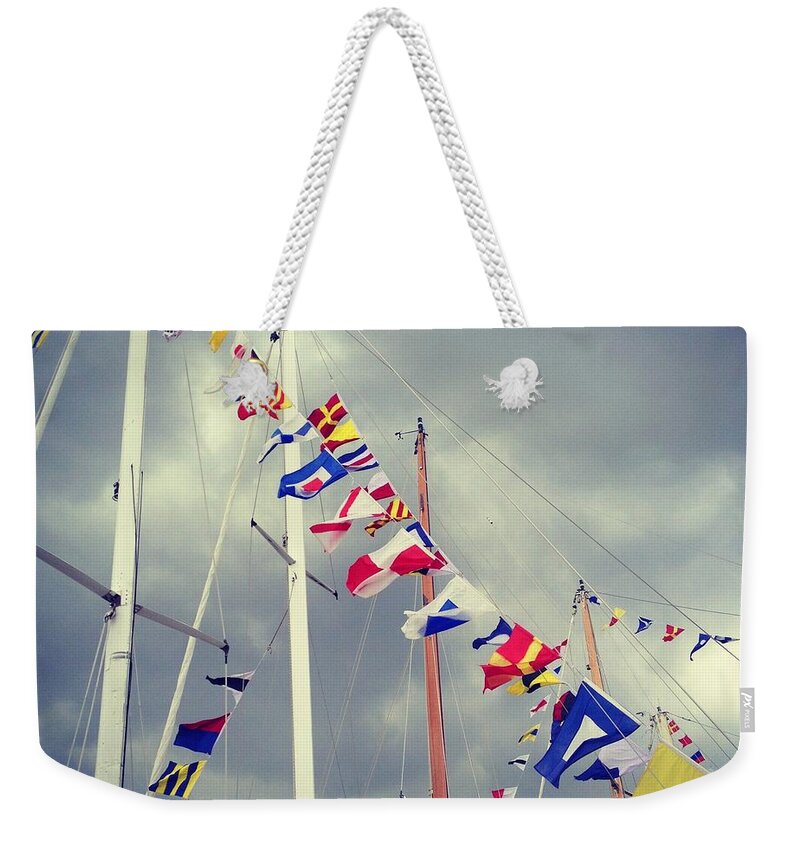 Pole Weekender Tote Bag featuring the photograph Marine Signal Flags On Mast Against A by Jodie Griggs
