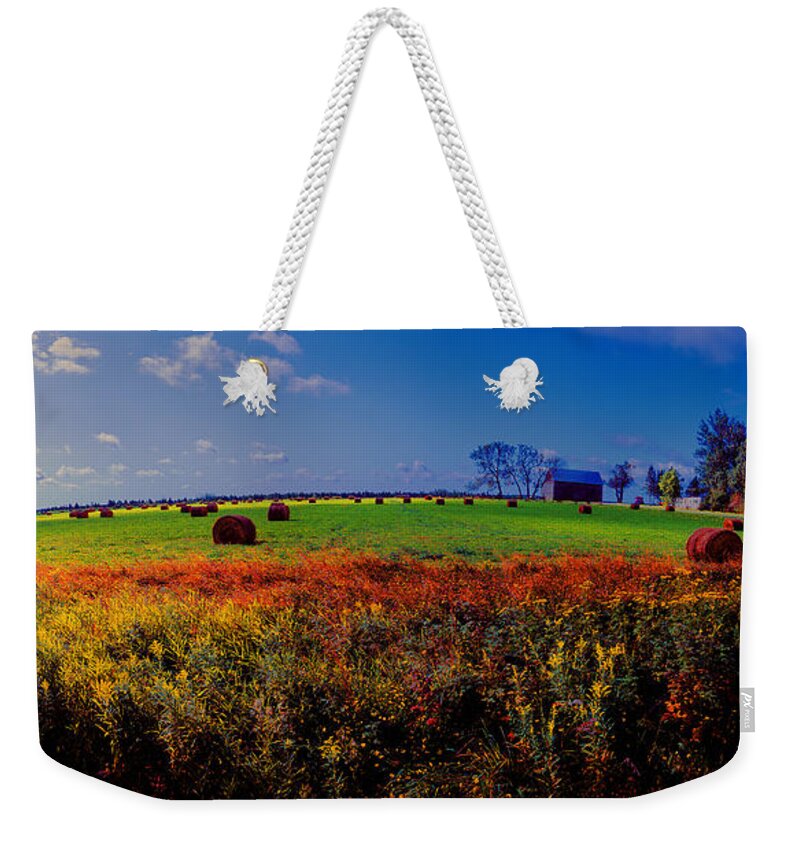 Michigan Weekender Tote Bag featuring the photograph Michigan Uper Farm Barn and Rolls of hay Brimly Michigan by Tom Jelen