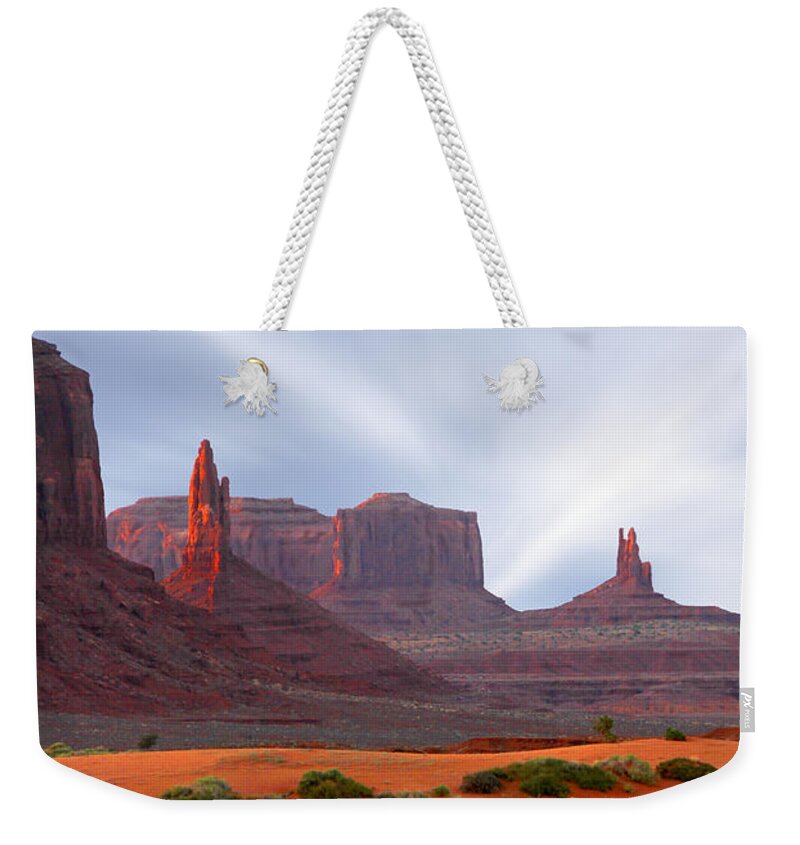 Desert Weekender Tote Bag featuring the photograph Monument Valley at Sunset Panoramic by Mike McGlothlen