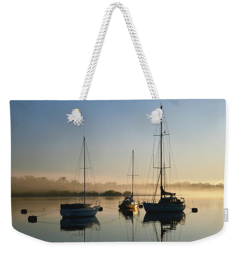 Sailboat Weekender Tote Bag featuring the photograph Moored Boats At Sunrise by Richard I'anson