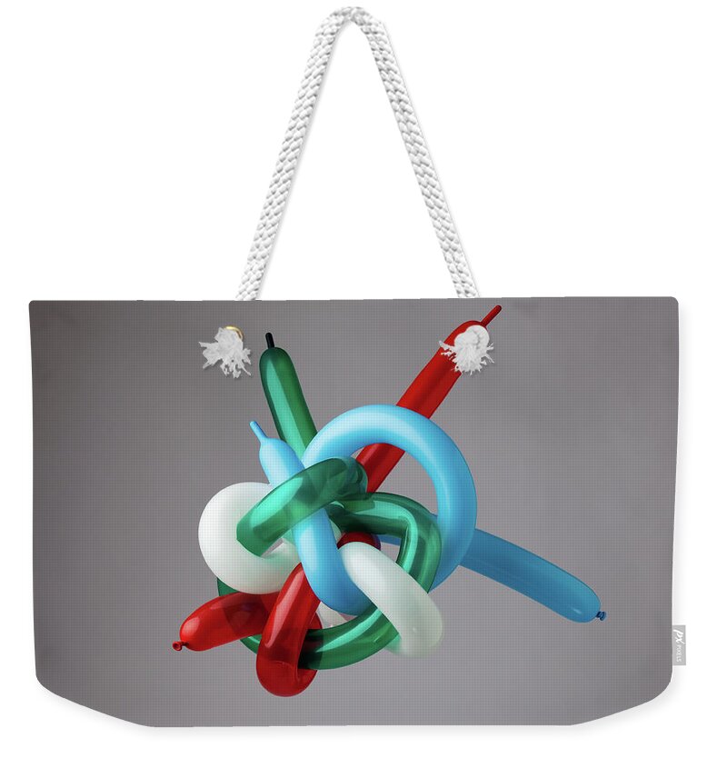 Large Group Of Objects Weekender Tote Bag featuring the photograph Muli-color Balloons Tied In Giant Knot by William Andrew