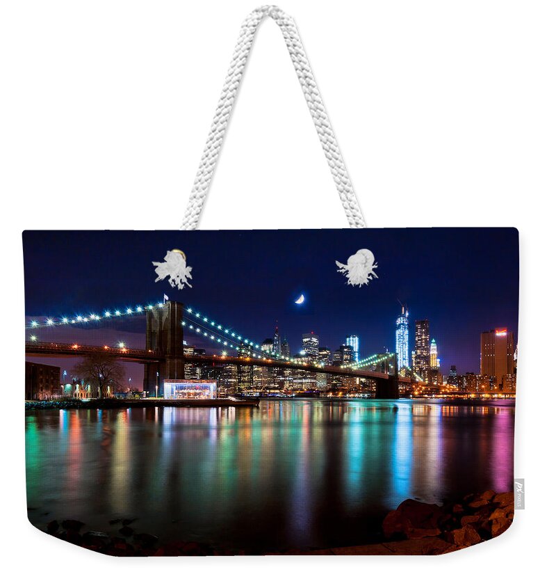 New York Weekender Tote Bag featuring the photograph New York Skyline and Brooklyn Bridge with Crescent Moon Rising by Mitchell R Grosky