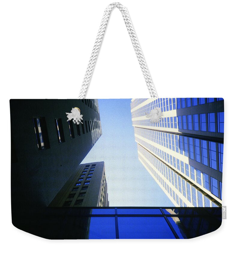 New York Weekender Tote Bag featuring the photograph 1984 New York City Skyscraper Canyon by Gordon James