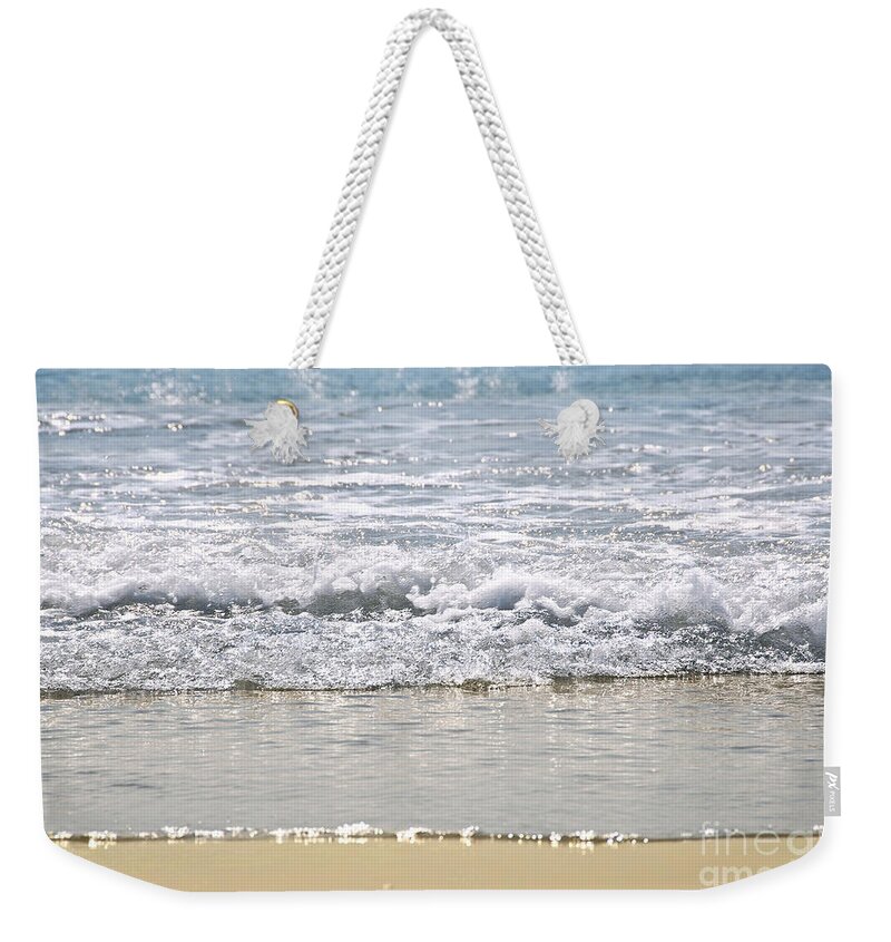 Water Weekender Tote Bag featuring the photograph Ocean shore with sparkling waves by Elena Elisseeva