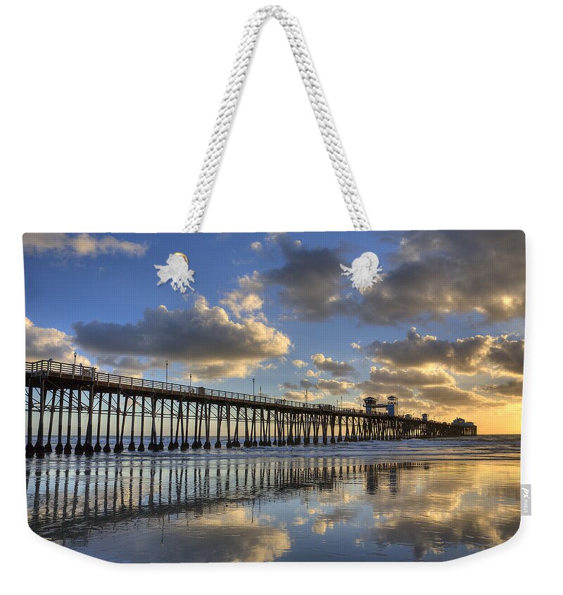 California Weekender Tote Bag featuring the photograph Oceanside Pier Sunset Reflection by Peter Tellone