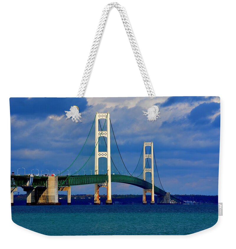 Michigan Weekender Tote Bag featuring the photograph October Sky Mackinac Bridge by Keith Stokes