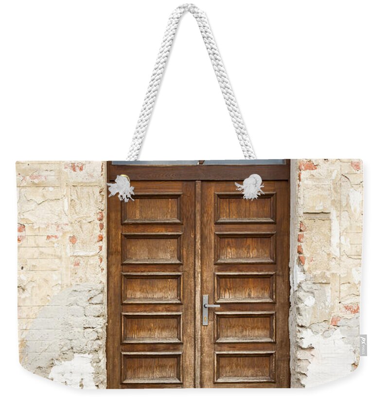 Old Weekender Tote Bag featuring the photograph Old church door by Les Palenik