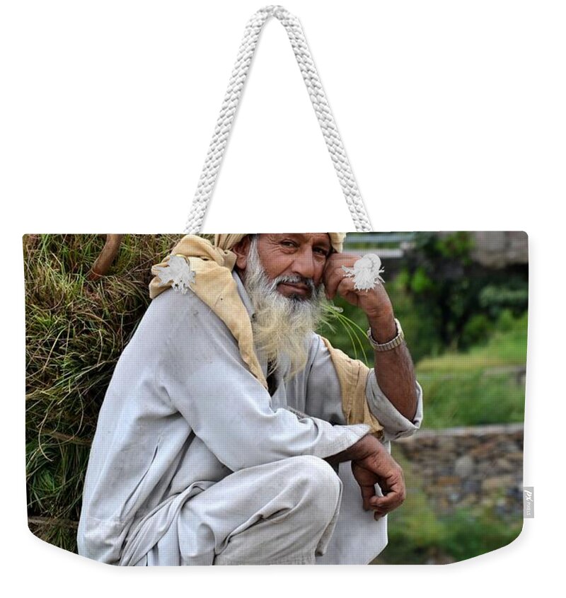 Old Man Weekender Tote Bag featuring the photograph Old man carrying fodder Swat Valley KPK Pakistan by Imran Ahmed