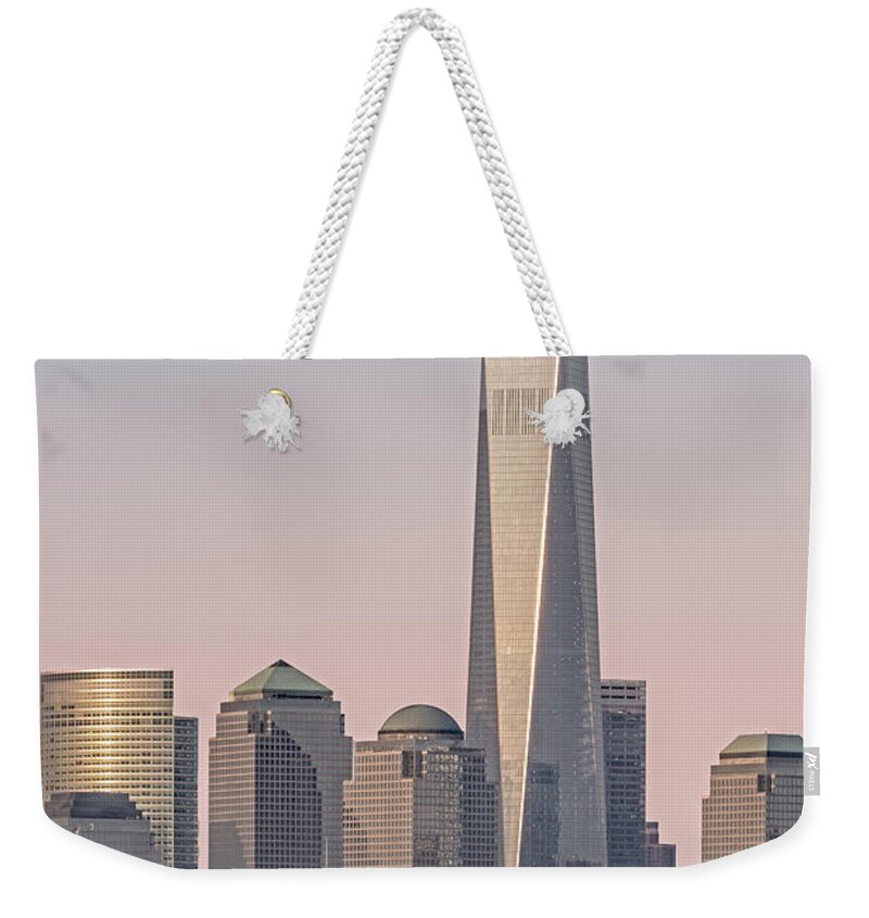 Freedom Tower Weekender Tote Bag featuring the photograph One World Trade Center And Ellis Island by Susan Candelario