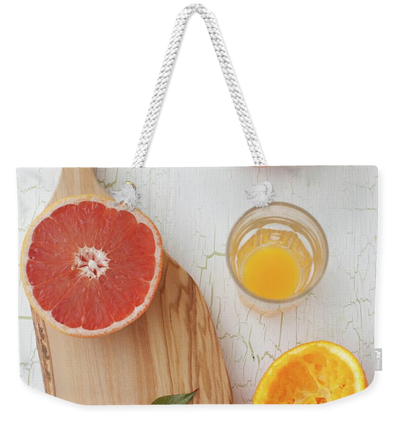 Orange Color Weekender Tote Bag featuring the photograph Orange And Grapefruit by Yelena Strokin