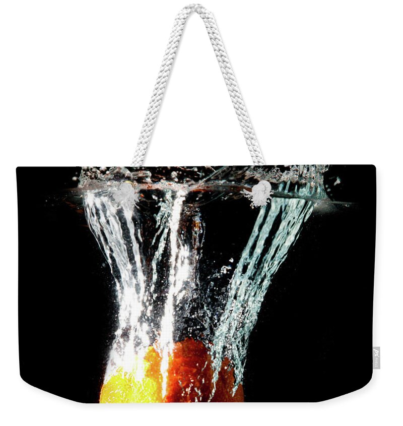 Orange Color Weekender Tote Bag featuring the photograph Orange Water Splash by Matthew Woitunski