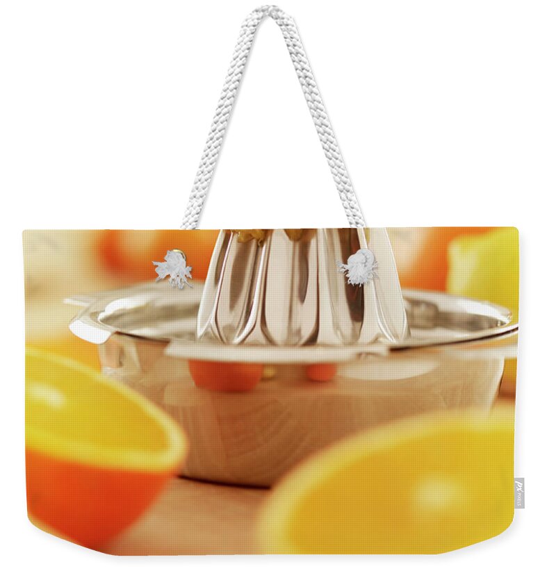 Orange Weekender Tote Bag featuring the photograph Oranges And Juicer by Adam Gault