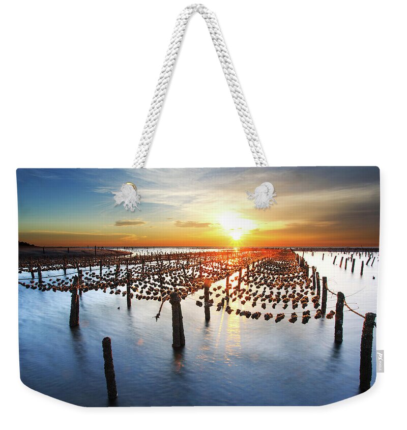 Pole Weekender Tote Bag featuring the photograph Oyster Farm On Beach During Sunset by Samyaoo
