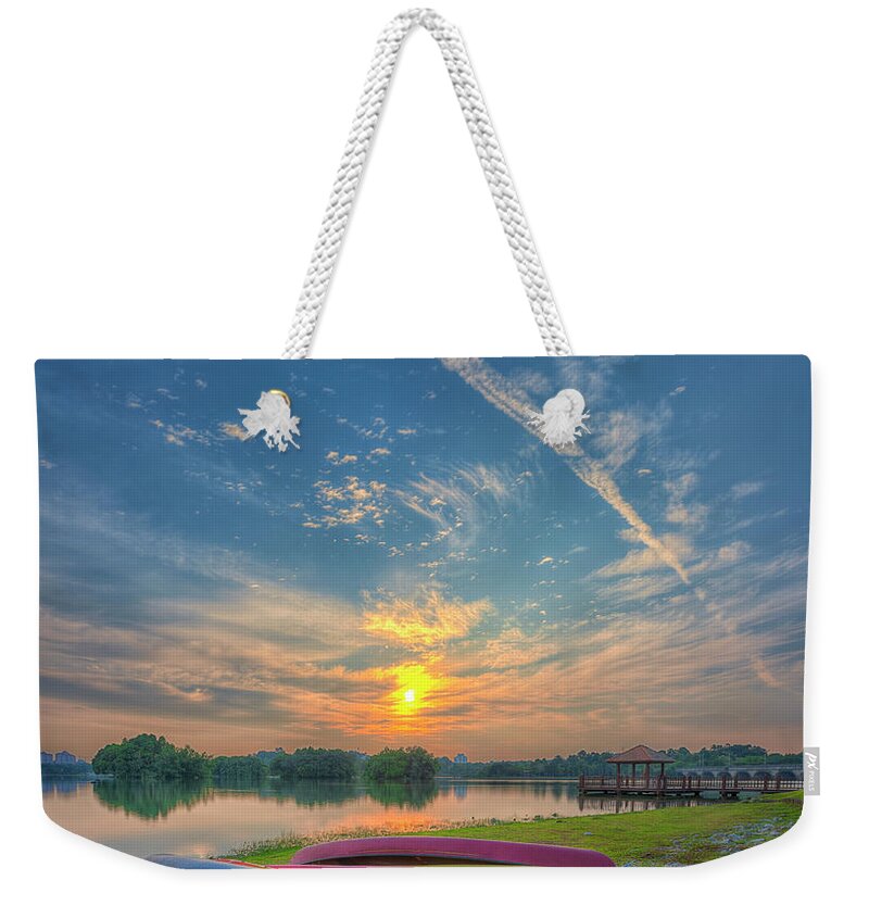 Scenics Weekender Tote Bag featuring the photograph Parked Canoes by Www.imagesbyhafiz.com