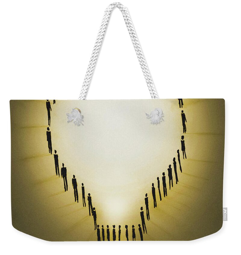 Adult Weekender Tote Bag featuring the photograph People Outlining Illuminated Light Bulb by Ikon Ikon Images