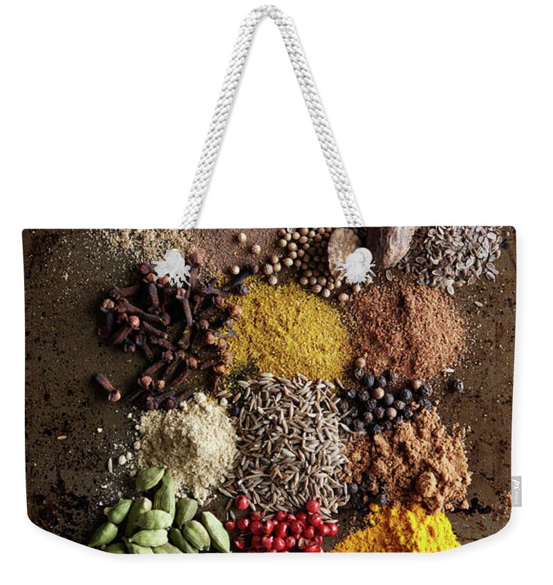 San Francisco Weekender Tote Bag featuring the photograph Piles Of Various Spices On Metal Surface by Maren Caruso