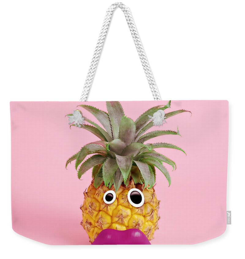 Googly Eyes Weekender Tote Bag featuring the photograph Pineapple With Face Made Of Fake Lips by Juj Winn