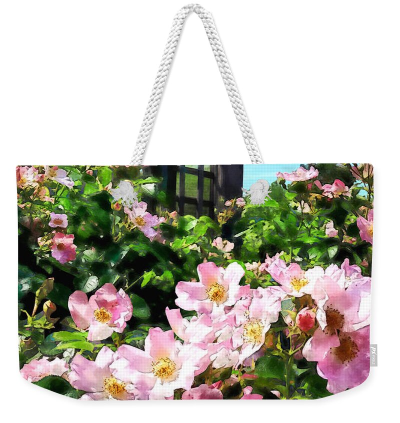 Rose Weekender Tote Bag featuring the photograph Pink Roses Near Trellis by Susan Savad