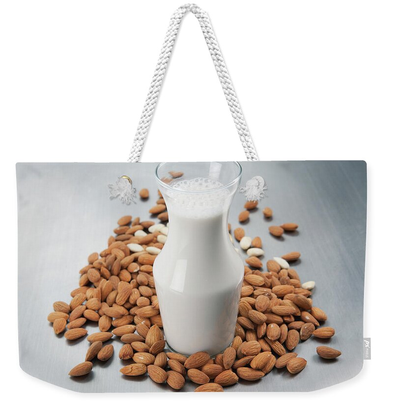 Almond Milk Weekender Tote Bag featuring the photograph Pitcher Of Milk And Raw Almonds by Laurie Castelli