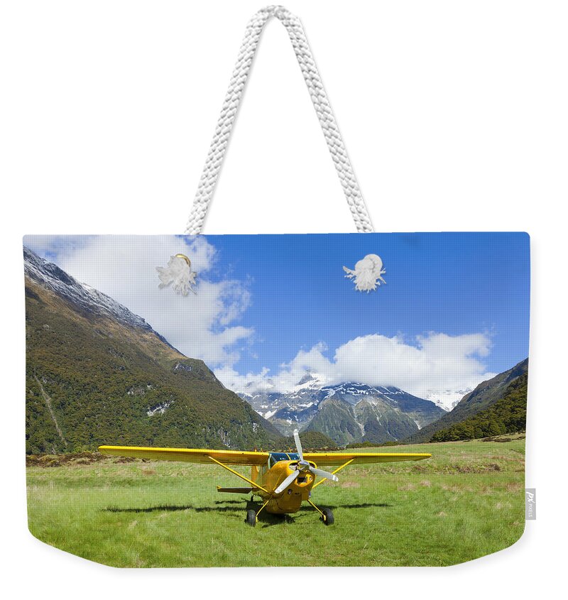 Valley Weekender Tote Bag featuring the photograph Plane in the Valley by Alexey Stiop