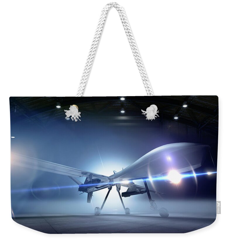 Airplane Weekender Tote Bag featuring the photograph Predator Drone At The Ready In A Hangar by Colin Anderson